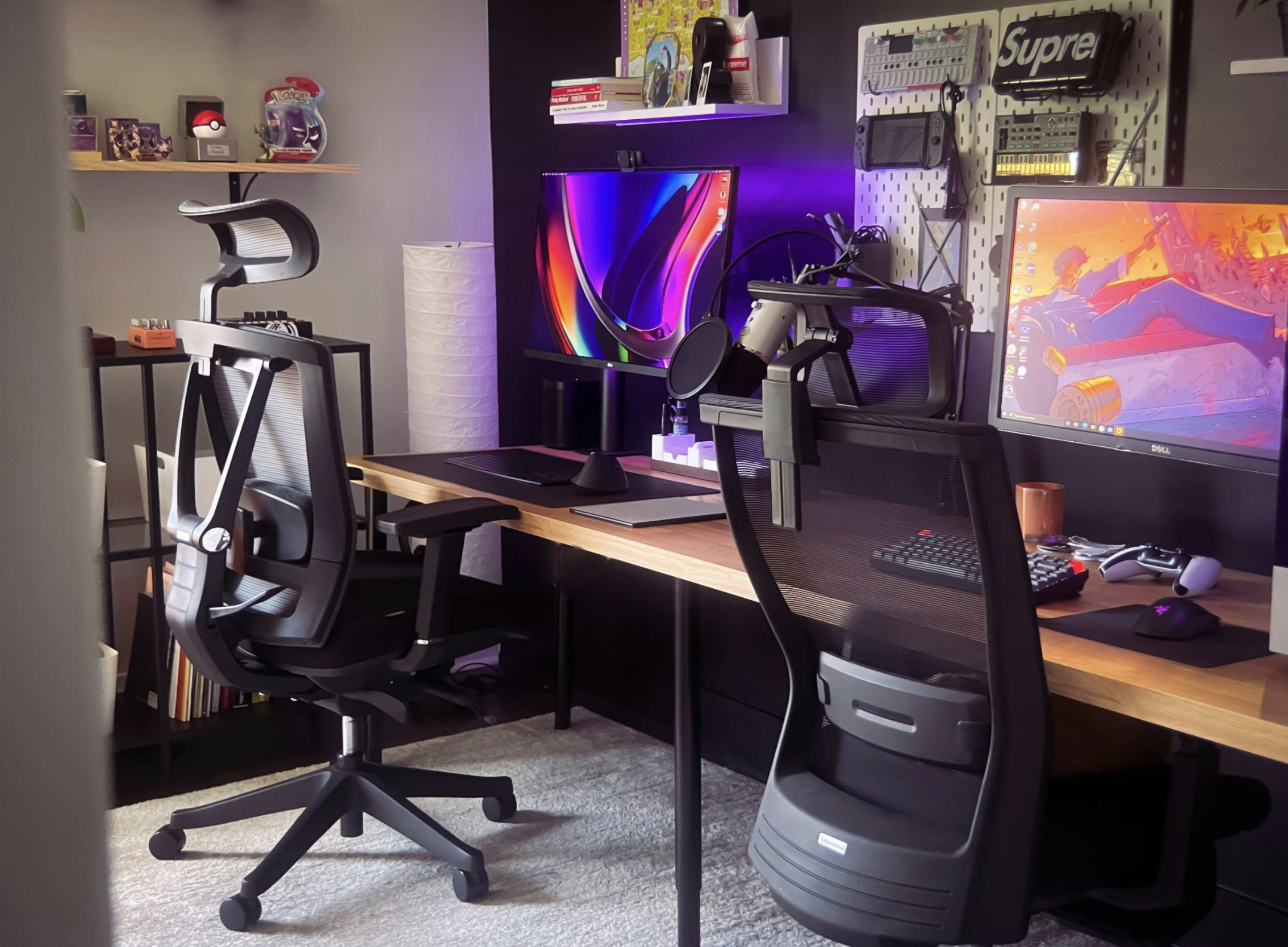 A futuristic game design studio with various digital tools displayed